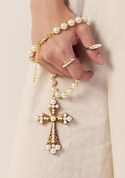 Hand holding a rosary with a cross, wearing silver rings  | Statement Necklace & Chokers  | neo jewelry 