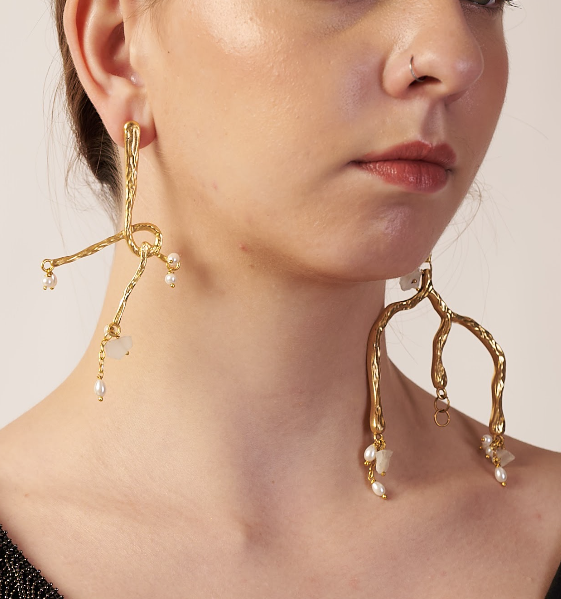 Gold earrings with pearl drops worn by a model | Statement Earring | neo jewelry