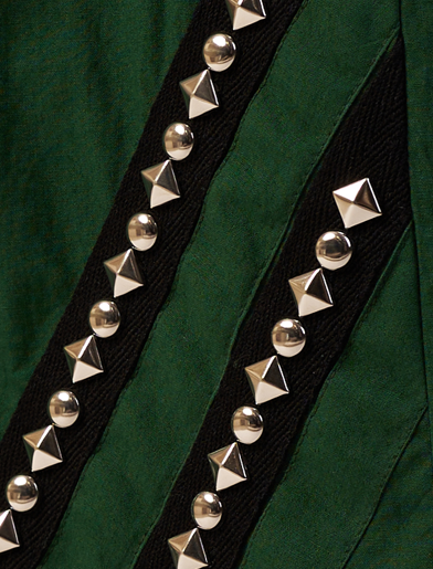Close-up of a green fabric with black ribbon and silver pyramid studs.  | Women Jumpsuit | Pret Clothes | nEo Clothes.