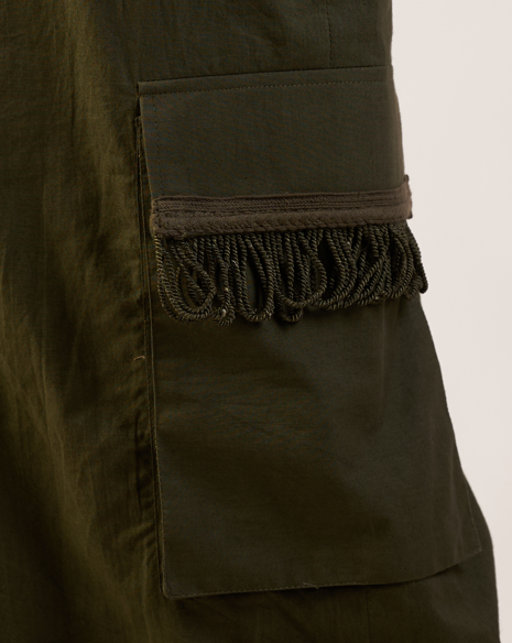 Close-up of a dark green jacket with frayed edge detail.  | Women Jumpsuit | Pret Clothes | nEo Clothes.