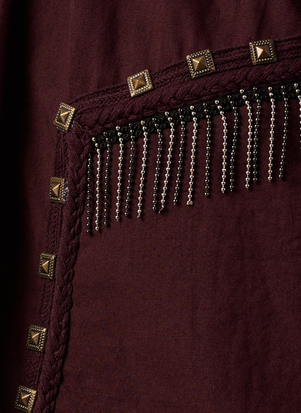 Close-up of a Coca Cola fabric with gold studs and black beaded fringe.  | Women Dresses | Pret Clothes | nEo Clothes.
