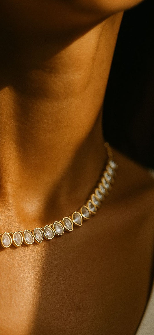 Model wearing gold double-row teardrop crystal necklace in soft studio lighting, highlighting its sparkly bridal-inspired design by Near Earth Object.
