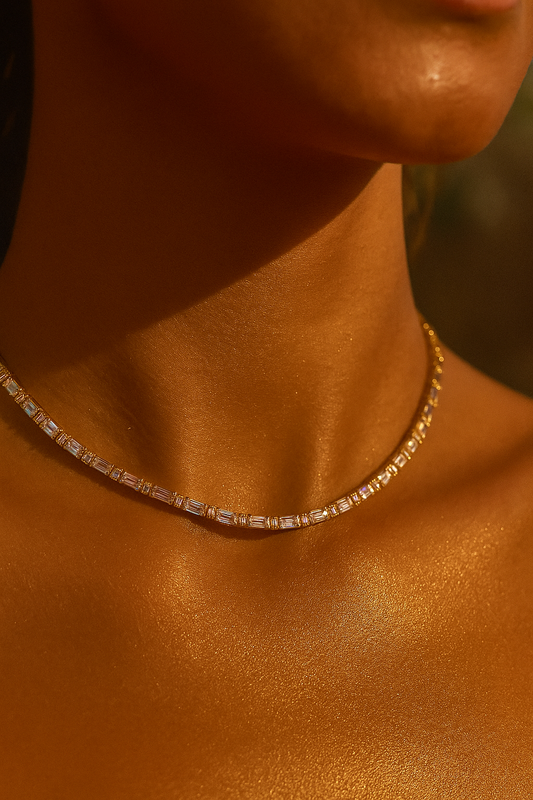 Model wearing gold crystal link necklace styled in warm golden lighting, emphasizing the necklace’s sparkle and premium finish.