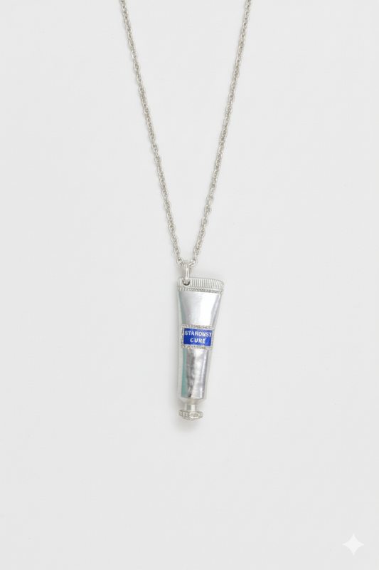 “Silver toothpaste-tube pendant necklace with detailed sculptural design – quirky artistic jewellery by Near Earth Object.