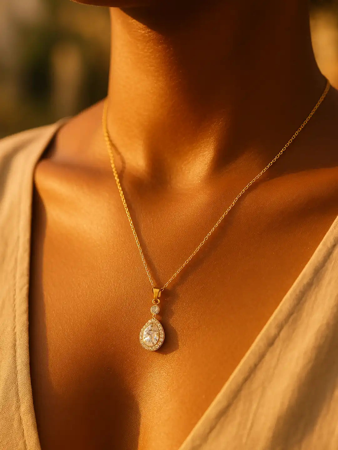 Gold necklace with a pendant on a person