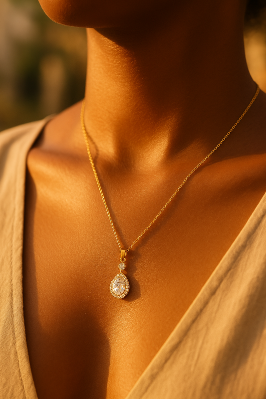 Model wearing gold teardrop pendant necklace – refined evening jewellery by Near Earth Object.