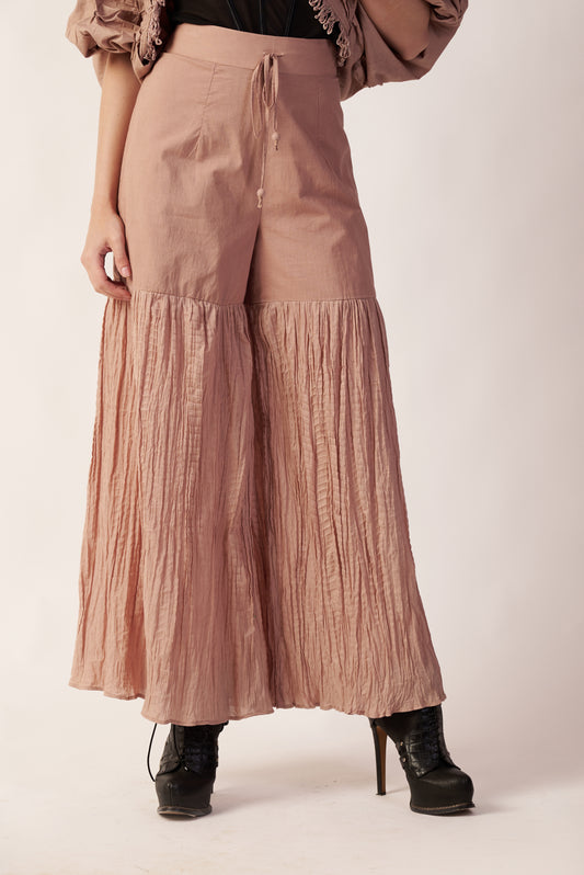 Stellar Flare Pant : Person wearing a pair of beige pleated pants - near Earth object | Women's Pants | Bottoms | Pret Clothes | nEo Clothes.