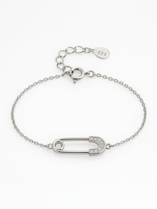 Silver bracelet featuring a crystal-studded safety-pin charm – edgy modern jewellery by Near Earth Object.