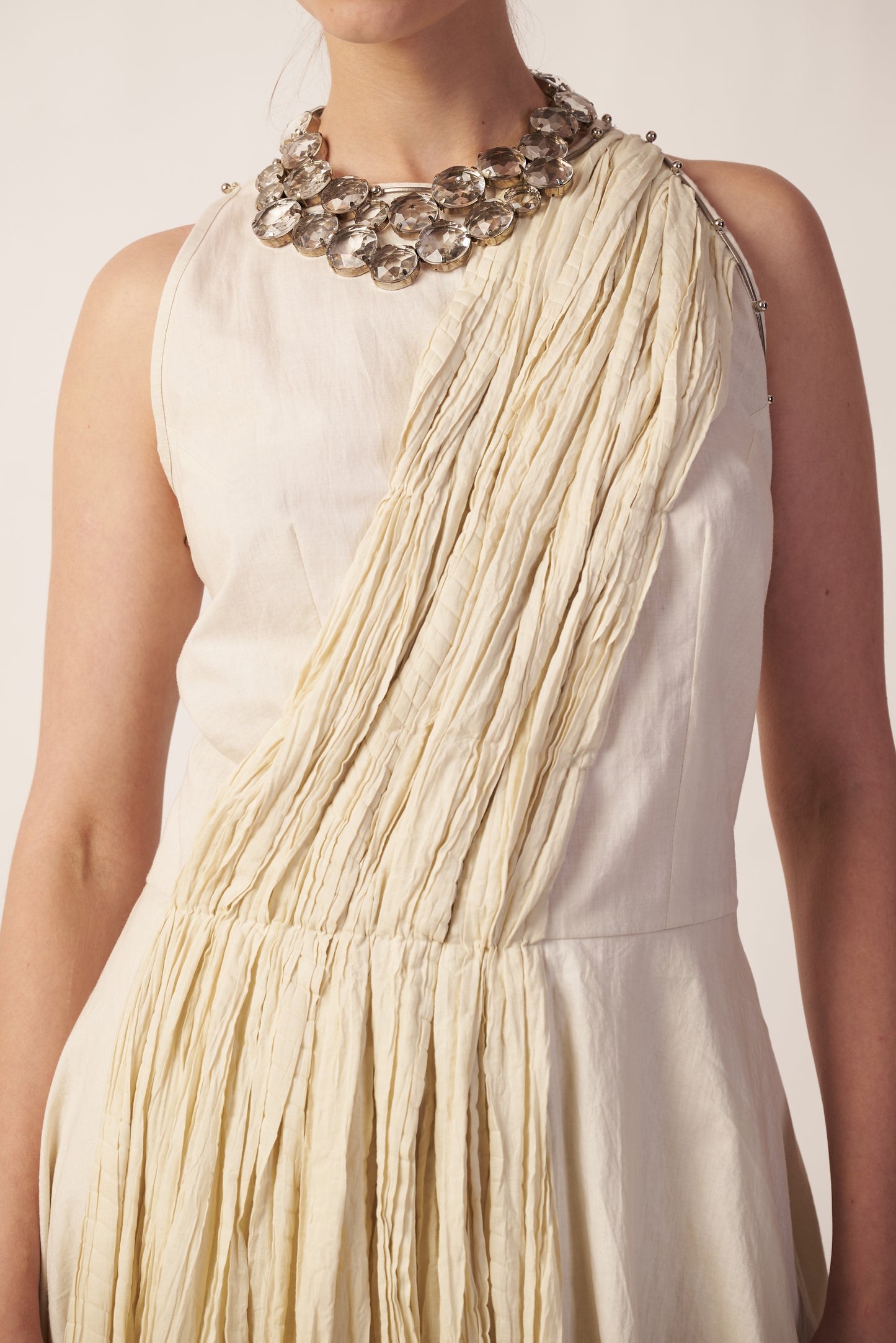 Stellar Pleat : Beige dress with fringe details and a decorative necklace near Earth object | Women Jumpsuit | Pret Clothes | nEo Clothes.