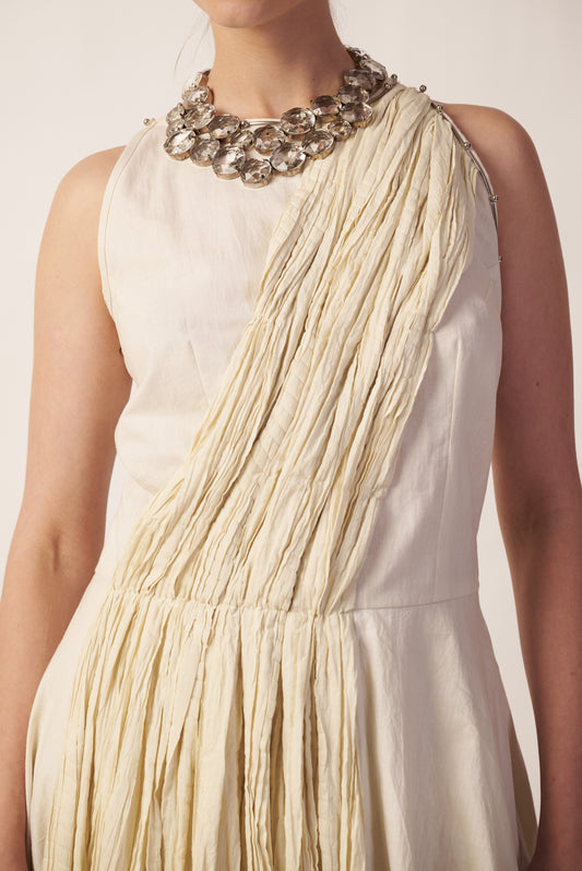 Stellar Pleat : Beige dress with fringe details and a decorative necklace near Earth object | Women Jumpsuit | Pret Clothes | nEo Clothes.