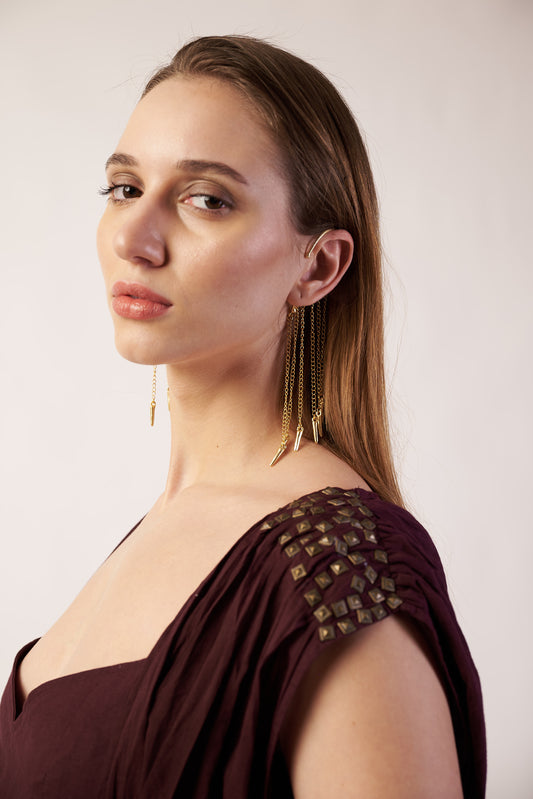 Model wearing gold cascading spear earrings – modern sculptural jewellery by Near Earth Object.