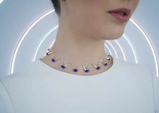 Model wearing sculptural wavy necklace with blue enamel accents – contemporary luxury jewellery by Near Earth Object.