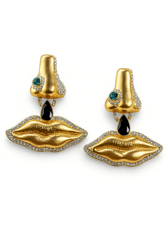 Gold surreal face earrings with sculpted lips and nose details – avant-garde statement jewellery by Near Earth Object.