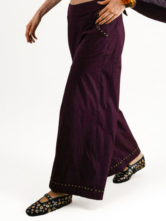 Supernova Flare Pants : Coca cola pants with studded details worn by a person - near Earth object | Women's Pants | Bottoms | Pret Clothes | nEo Clothes.