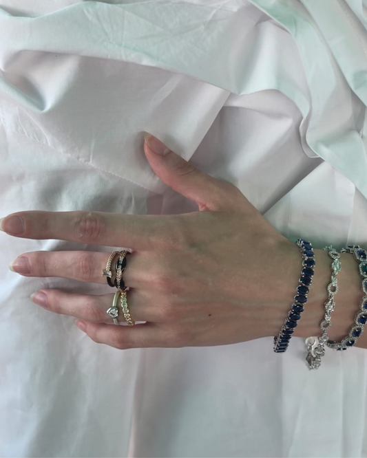 Model wearing mixed-metal gold and silver ring set – statement ring stacking style by Near Earth Object.