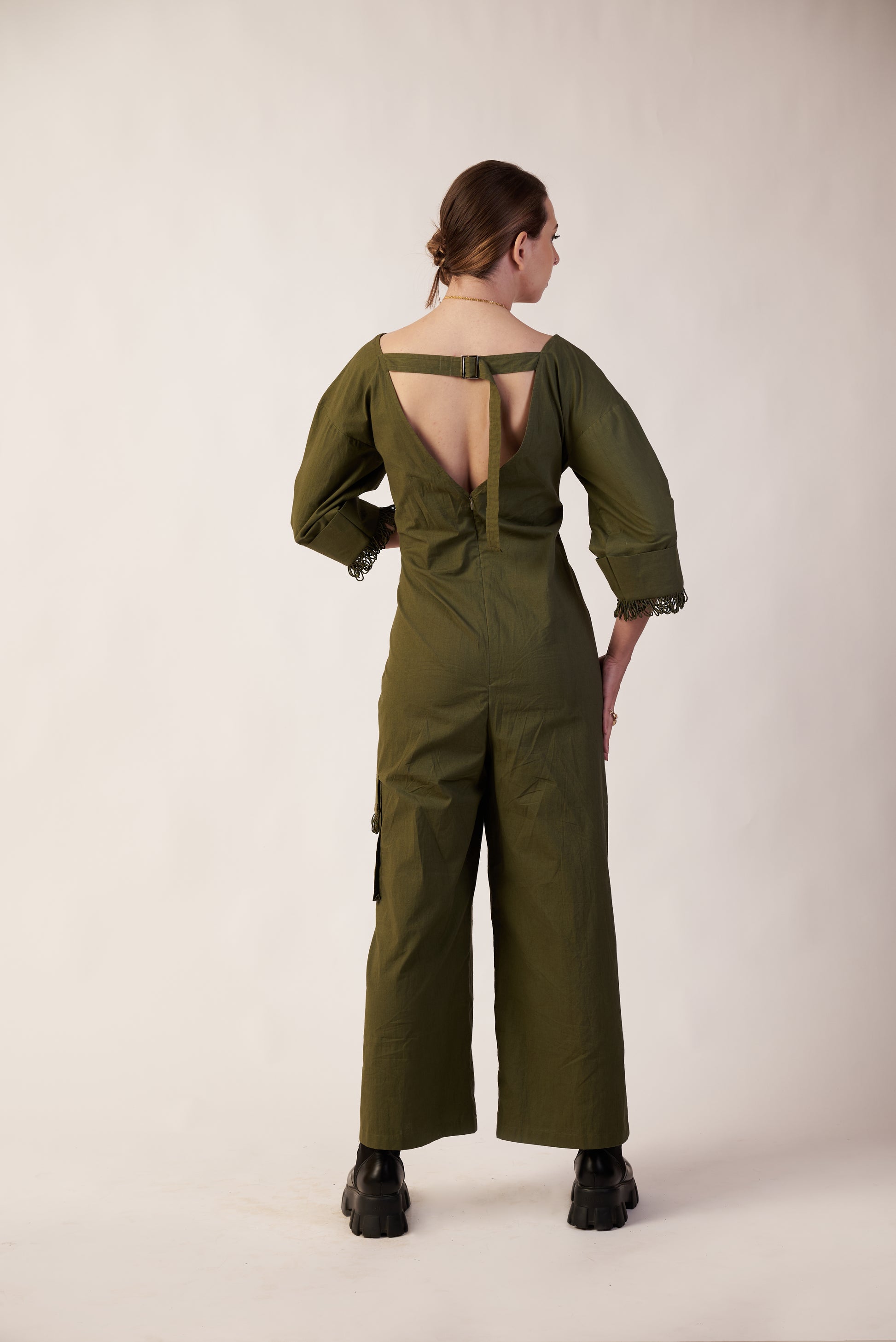 Person wearing a green jumpsuit with open back  | Women Jumpsuit | Pret Clothes | nEo Clothes.