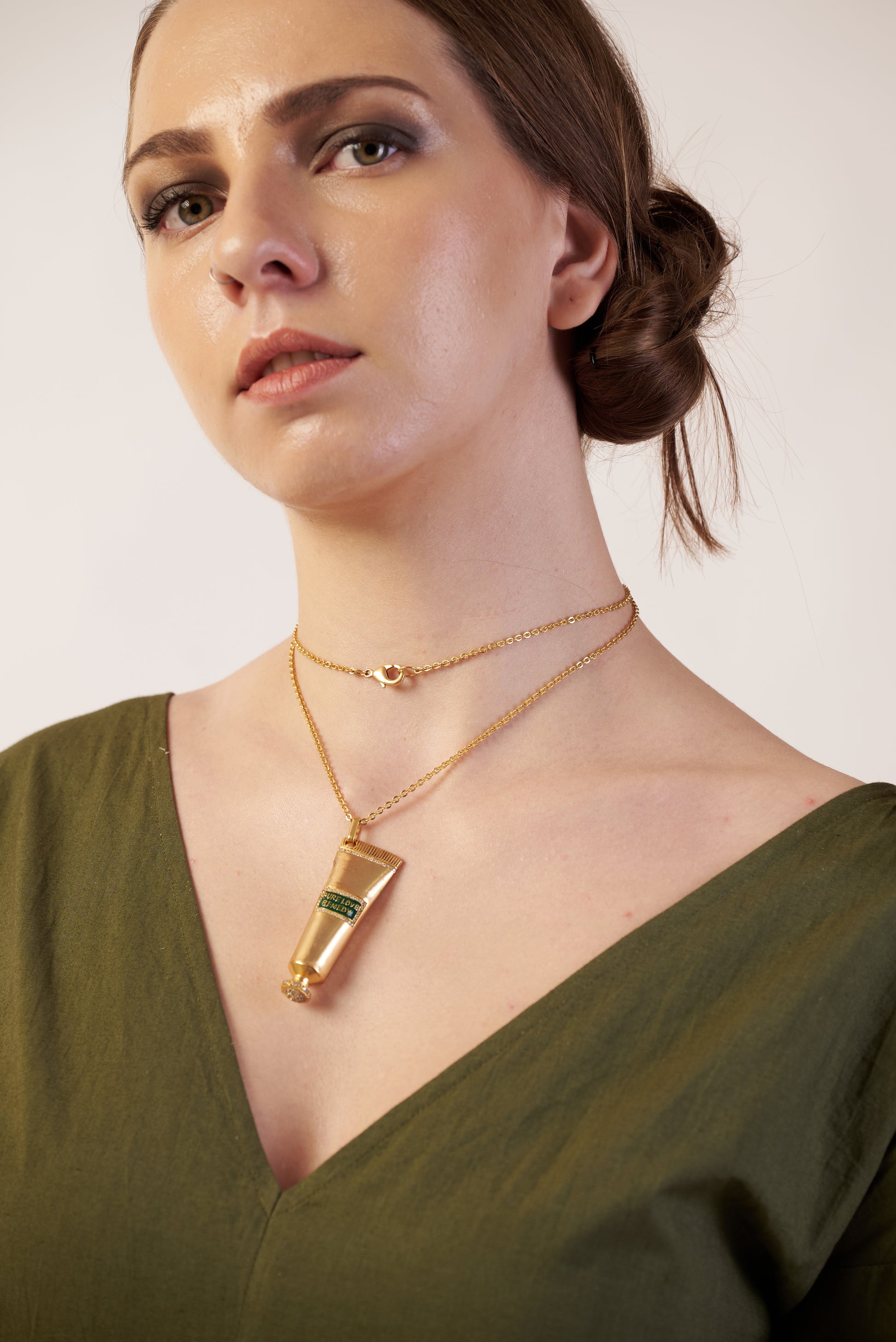 Woman wearing a gold necklace with a green gemstone  | Women Jumpsuit | Pret Clothes | nEo Clothes.