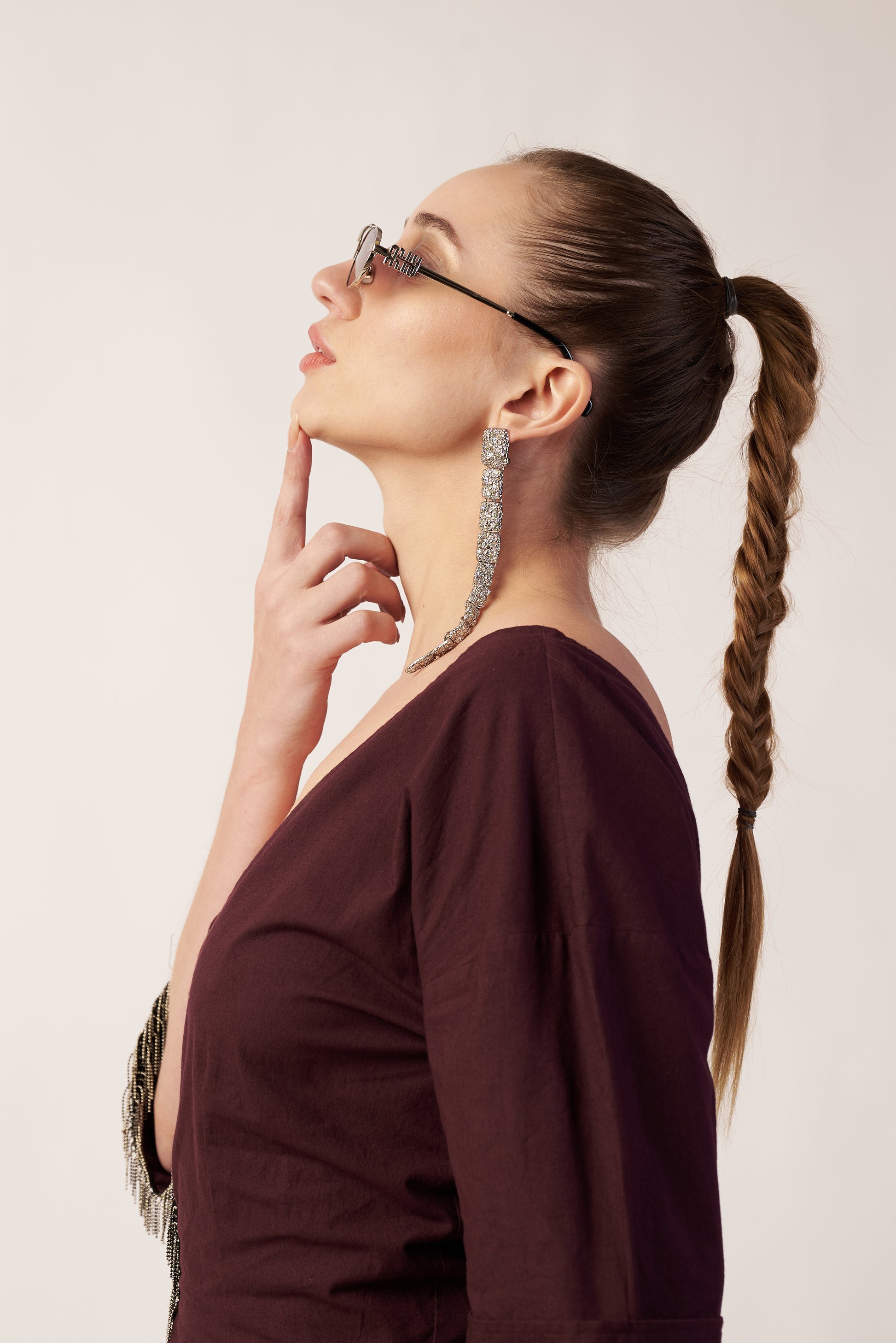 Woman with braided hair wearing glasses and a dark top  | Women Dresses | Pret Clothes | nEo Clothes.
