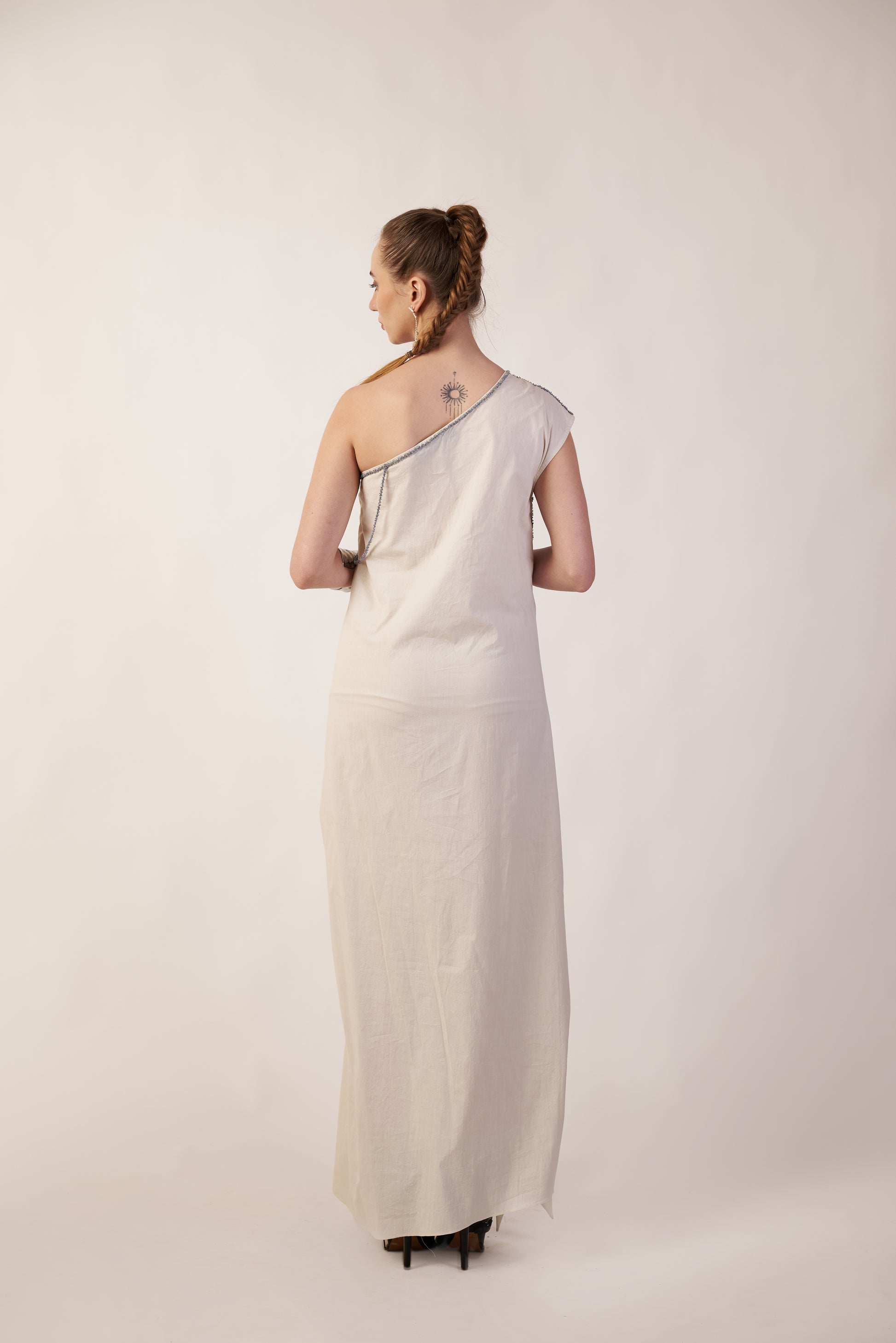 Woman wearing a long, light-colored dress | Women Dresses | Pret Clothes | nEo Clothes.