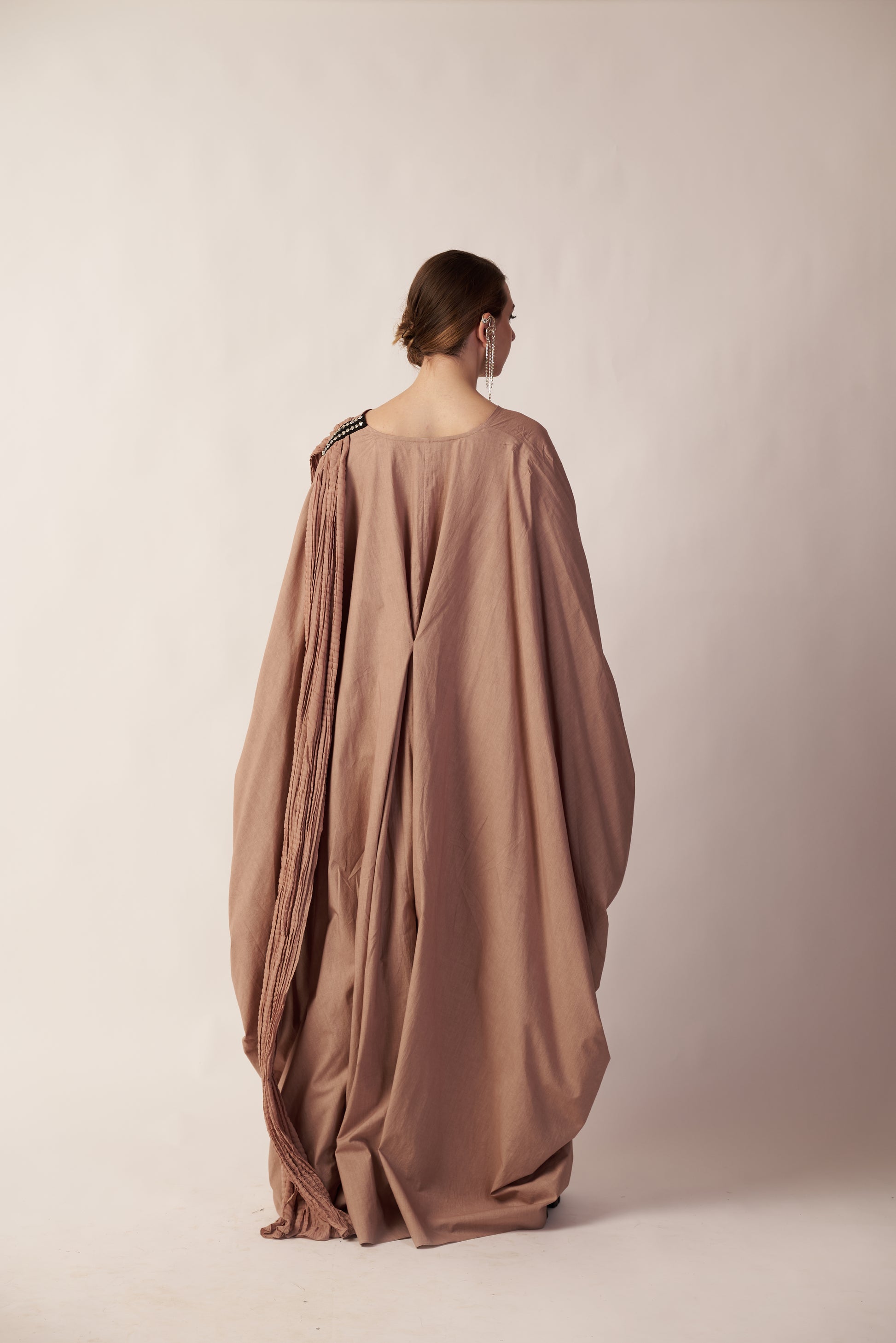 Woman wearing a long, flowing brown dress | Women Dresses | Pret Clothes | nEo Clothes.