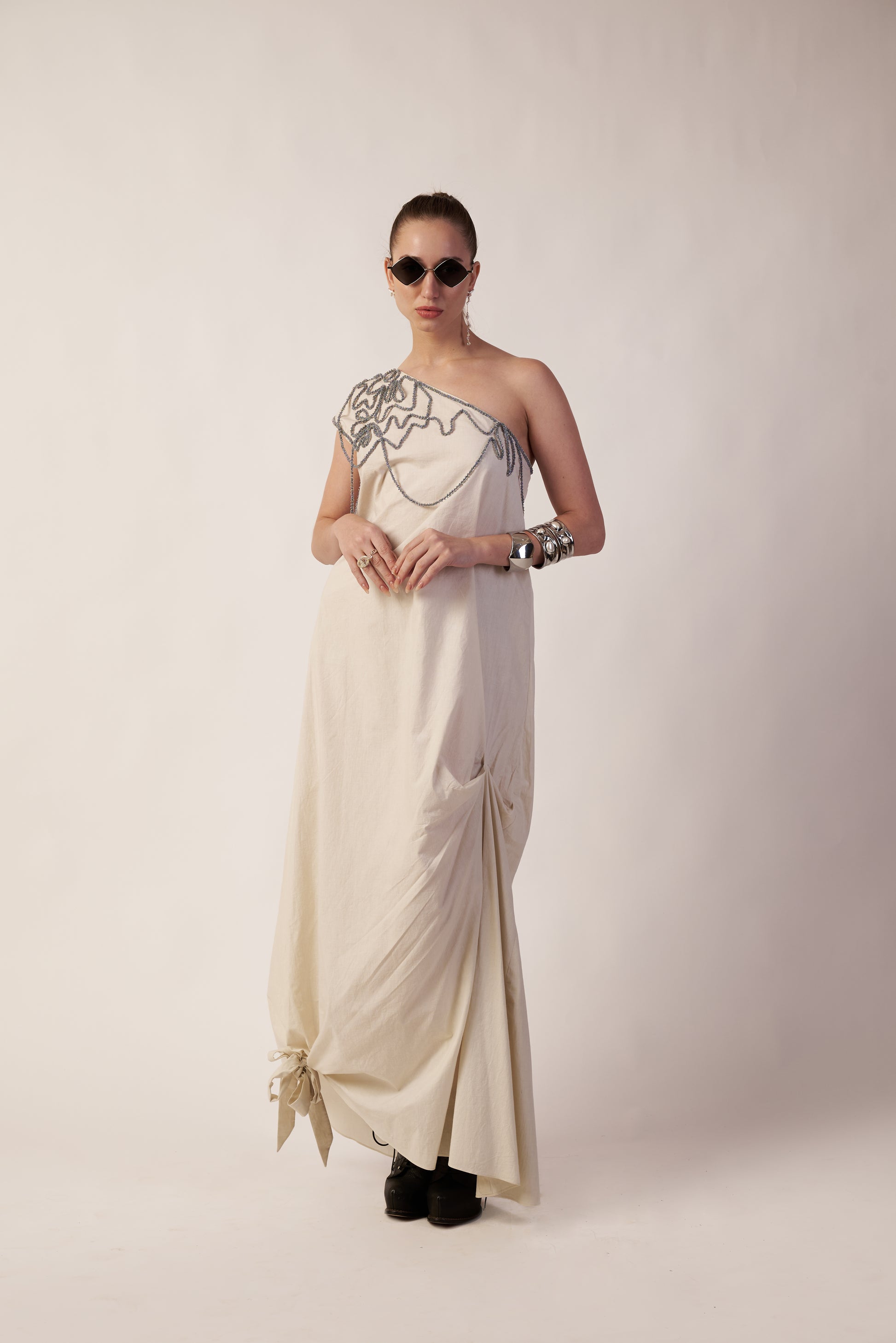 Woman wearing a one-shoulder dress with intricate detailing  | Women Dresses | Pret Clothes | nEo Clothes.