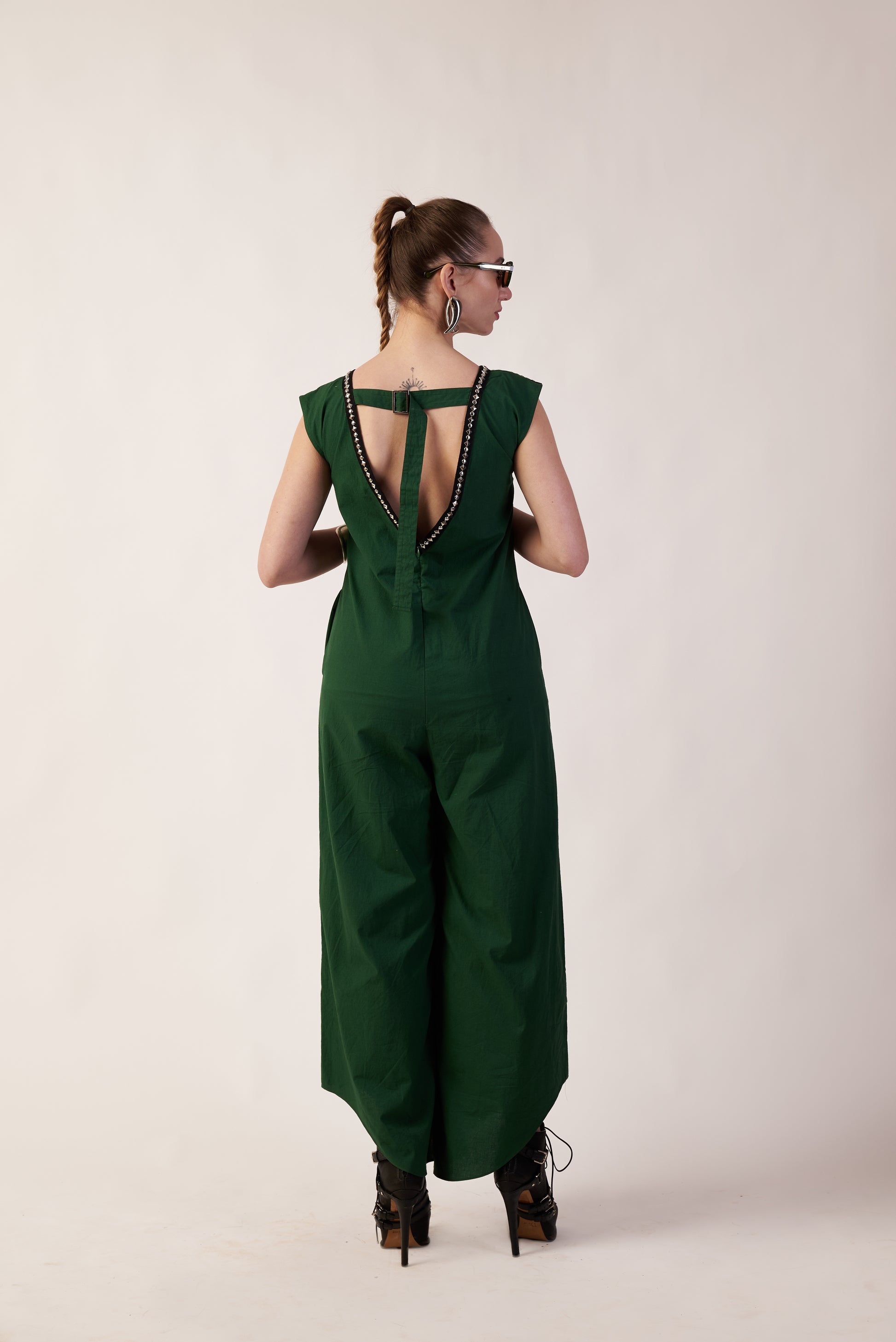 Woman wearing a green jumpsuit with a unique back design o | Women Jumpsuit | Pret Clothes | nEo Clothes.