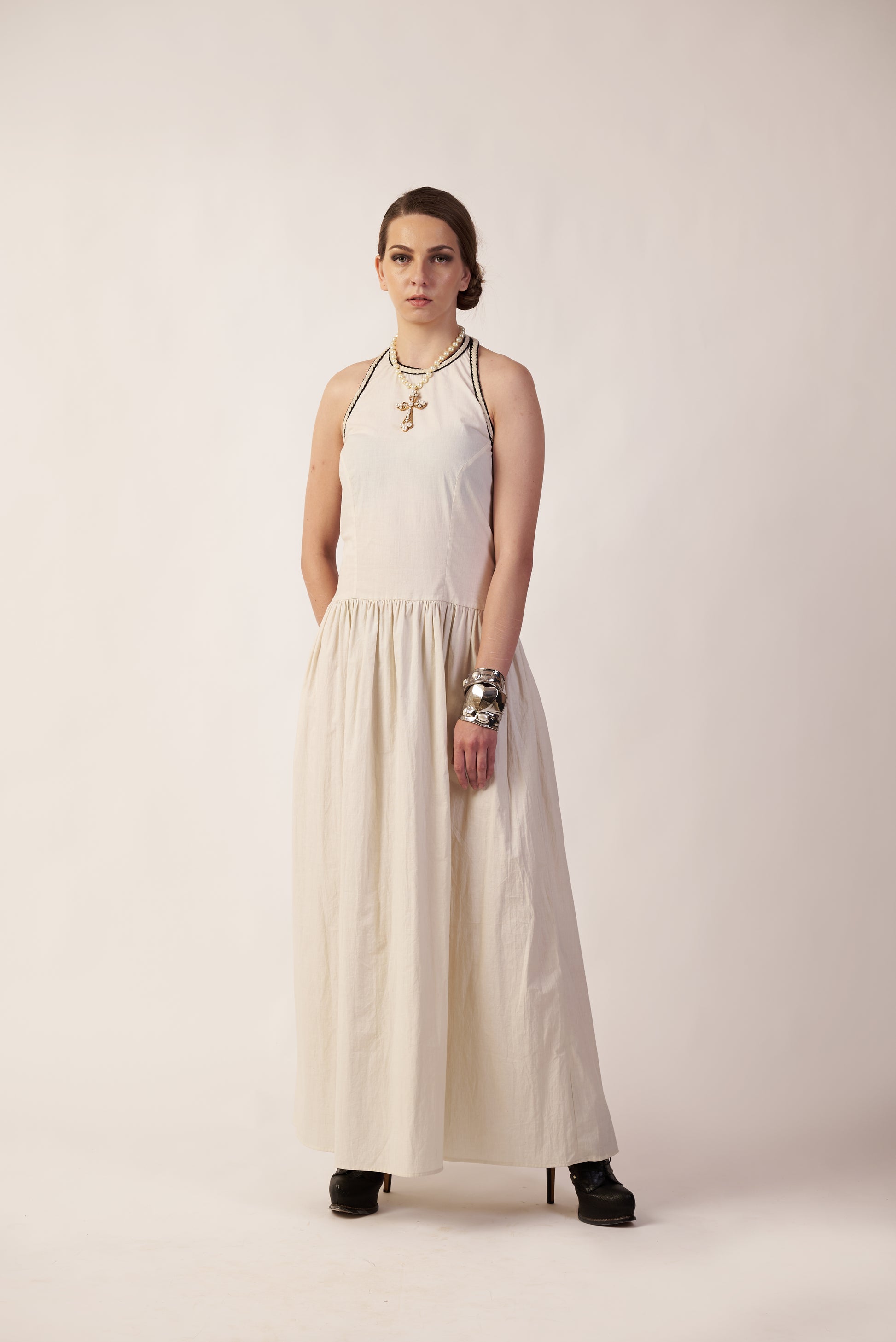 Woman wearing a white dress with a halter neck design | Women Dresses | Pret Clothes | nEo Clothes.