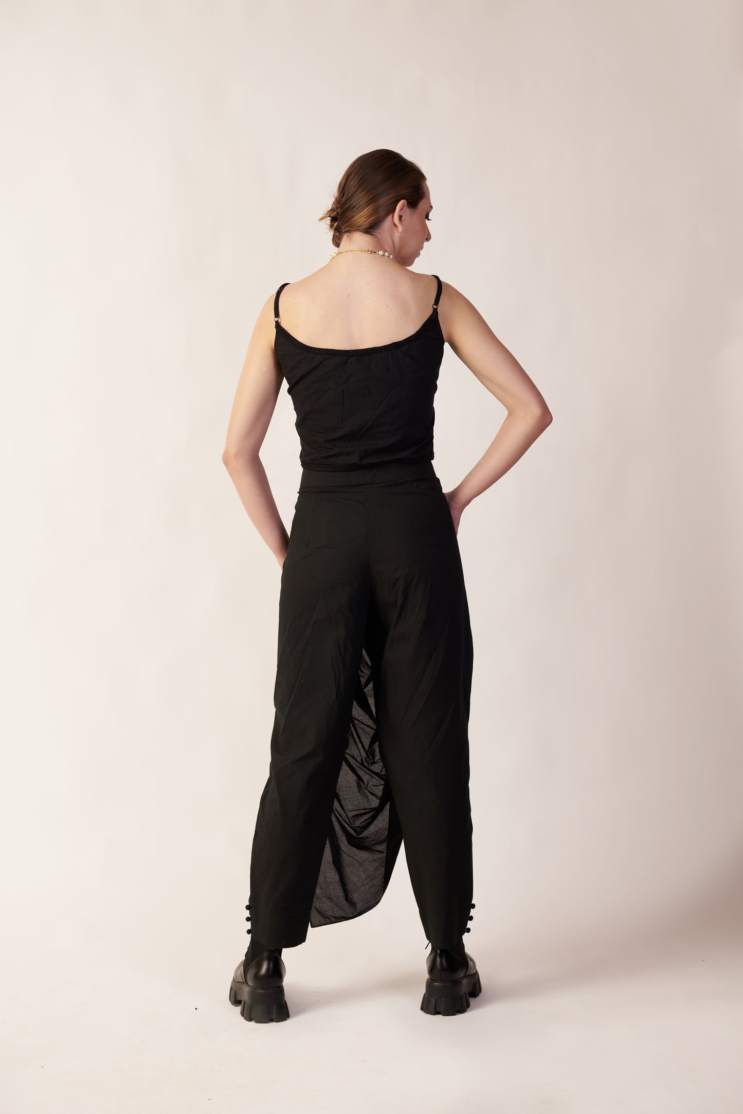 Person wearing a black sleeveless top and wide-leg pants o | Women Co-ord Set | Pret Clothes | nEo Clothes.