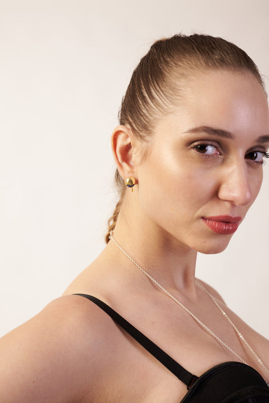 Woman with braided hair wearing a gold earrings | Statement Earring | neo jewelry