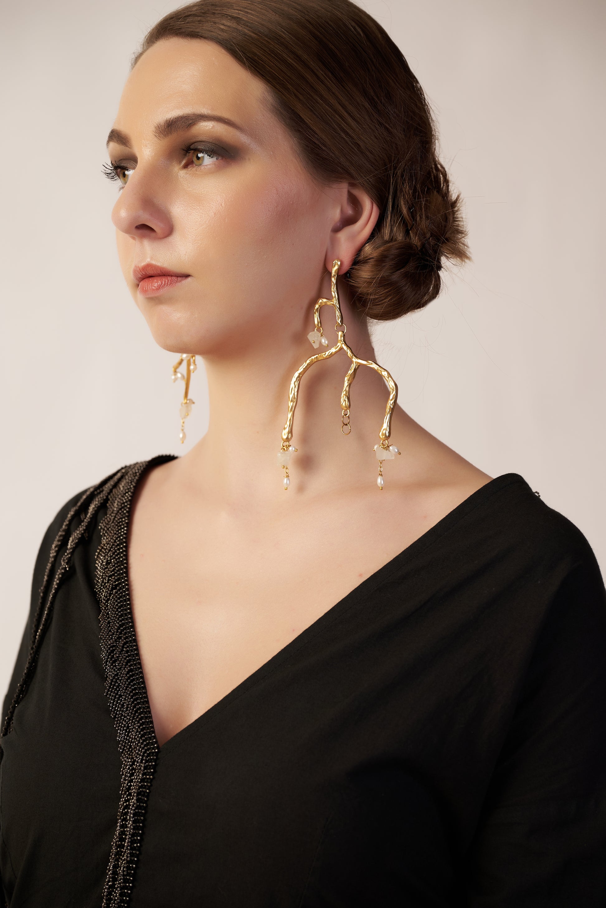 Woman wearing gold earrings | Statement Earring | neo jewelry