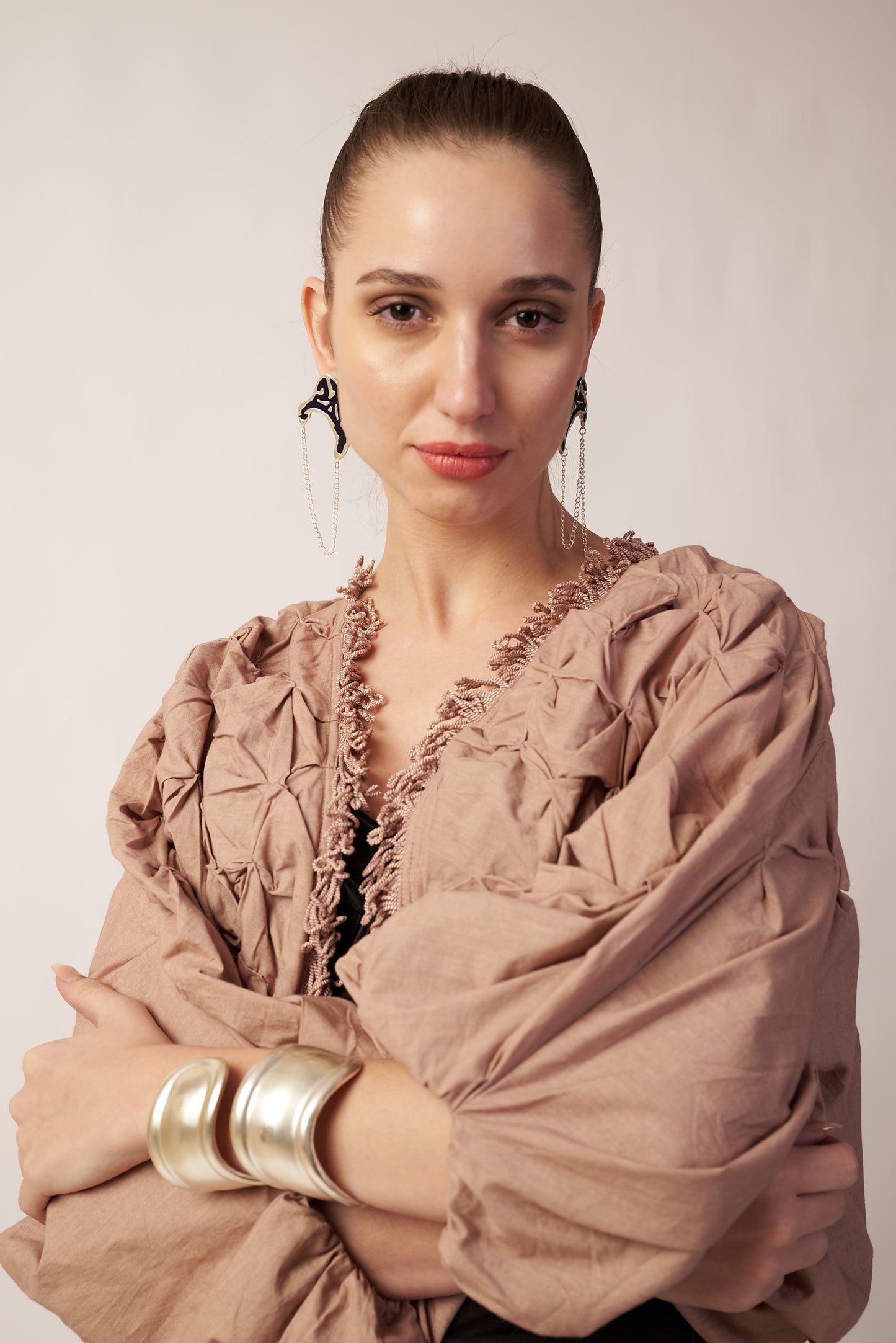 Woman wearing a beige shawl with wearing blue earrings | Statement Ear Cuffs | neo jewelry 