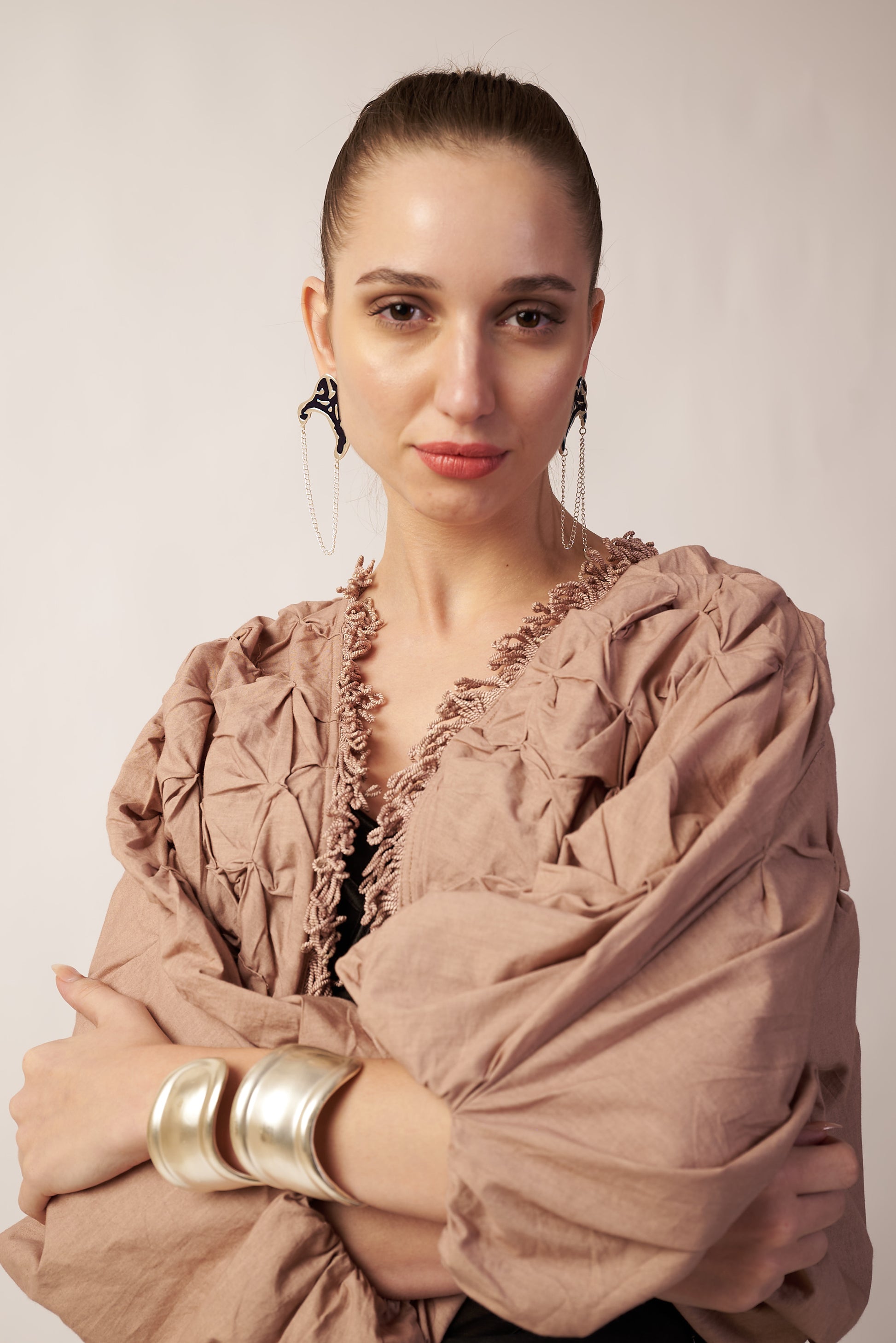 Woman wearing a beige shawl with wearing blue earrings | Statement Ear Cuffs | neo jewelry 