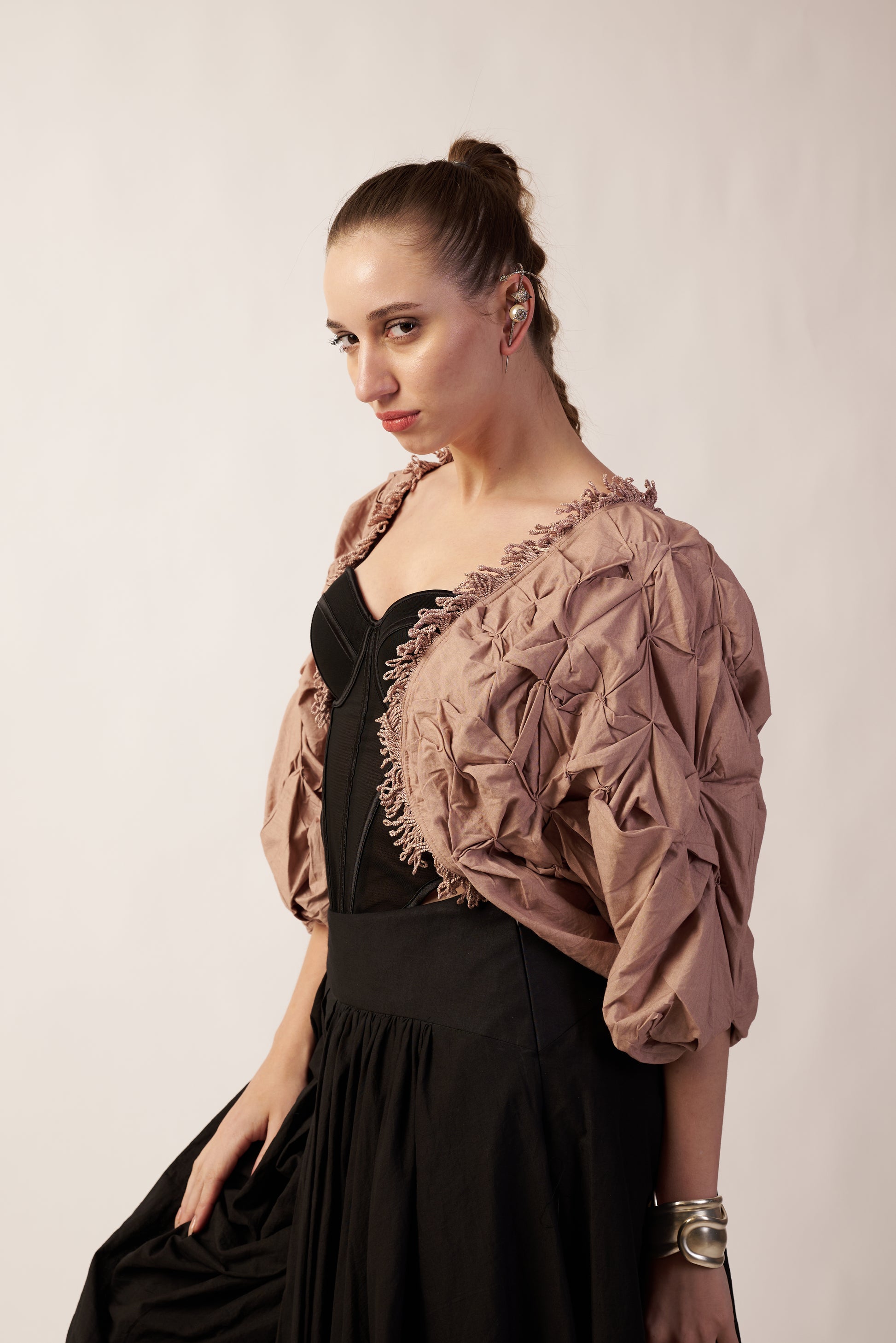 Woman wearing a textured beige shrug over a black dress | Women's Shrug | Jacket | Pret Clothes | nEo Clothes.