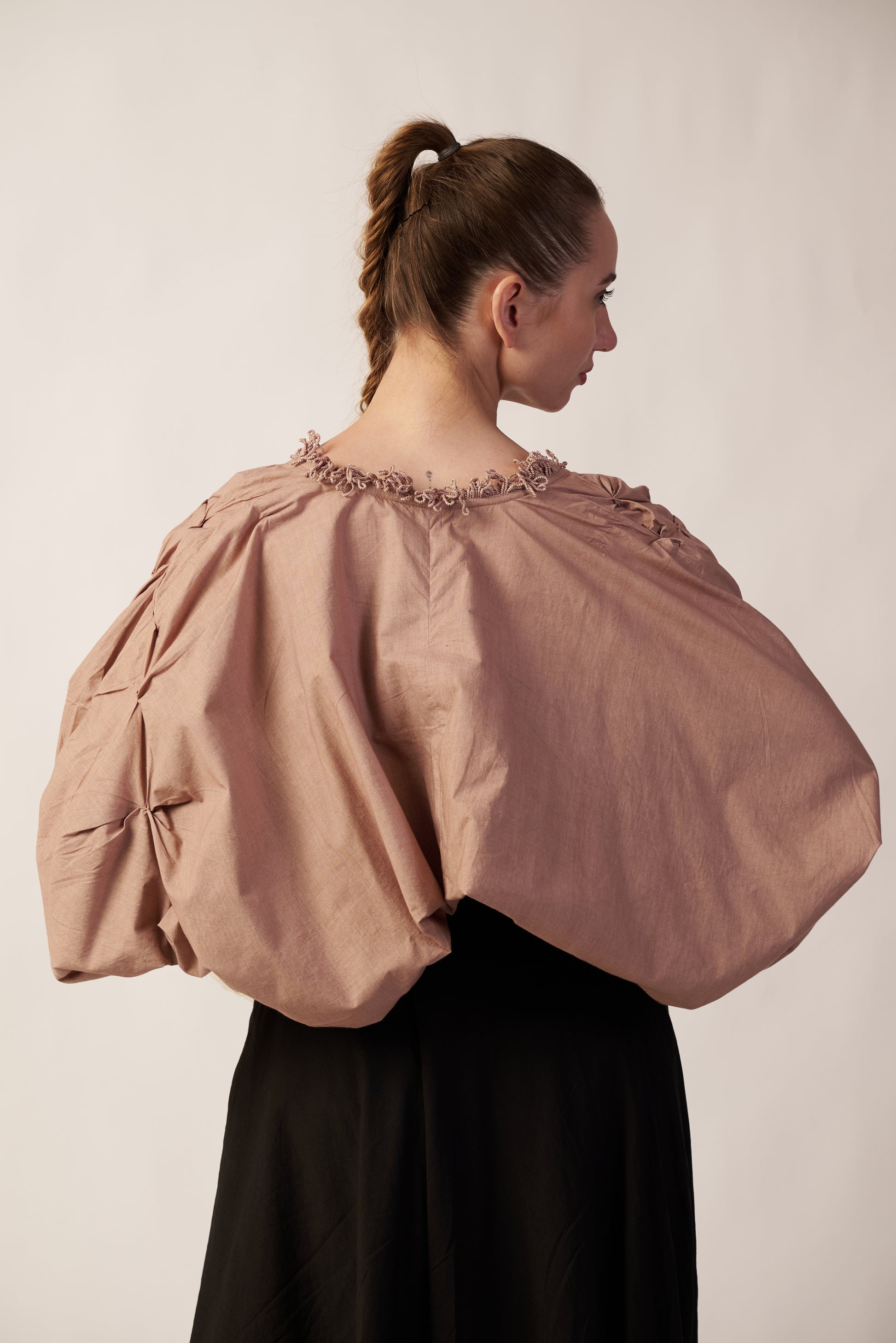 Woman wearing a beige shrug with puffed sleeves and floral embellishments | Women's Shrug | Jacket | Pret Clothes | nEo Clothes.
