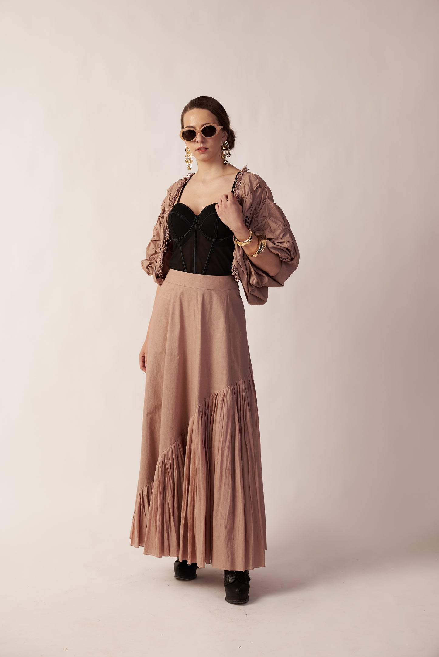 Woman wearing a black top and long beige skirt with a light beige jacket  | Women's Skirt | Bottoms | Pret Clothes | nEo Clothes.against a white background