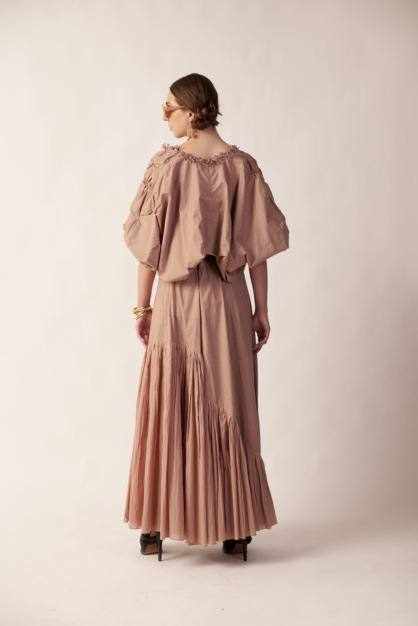 Woman wearing a long, light beige dress with puffed sleeves  | Women's Skirt | Bottoms | Pret Clothes | nEo Clothes.