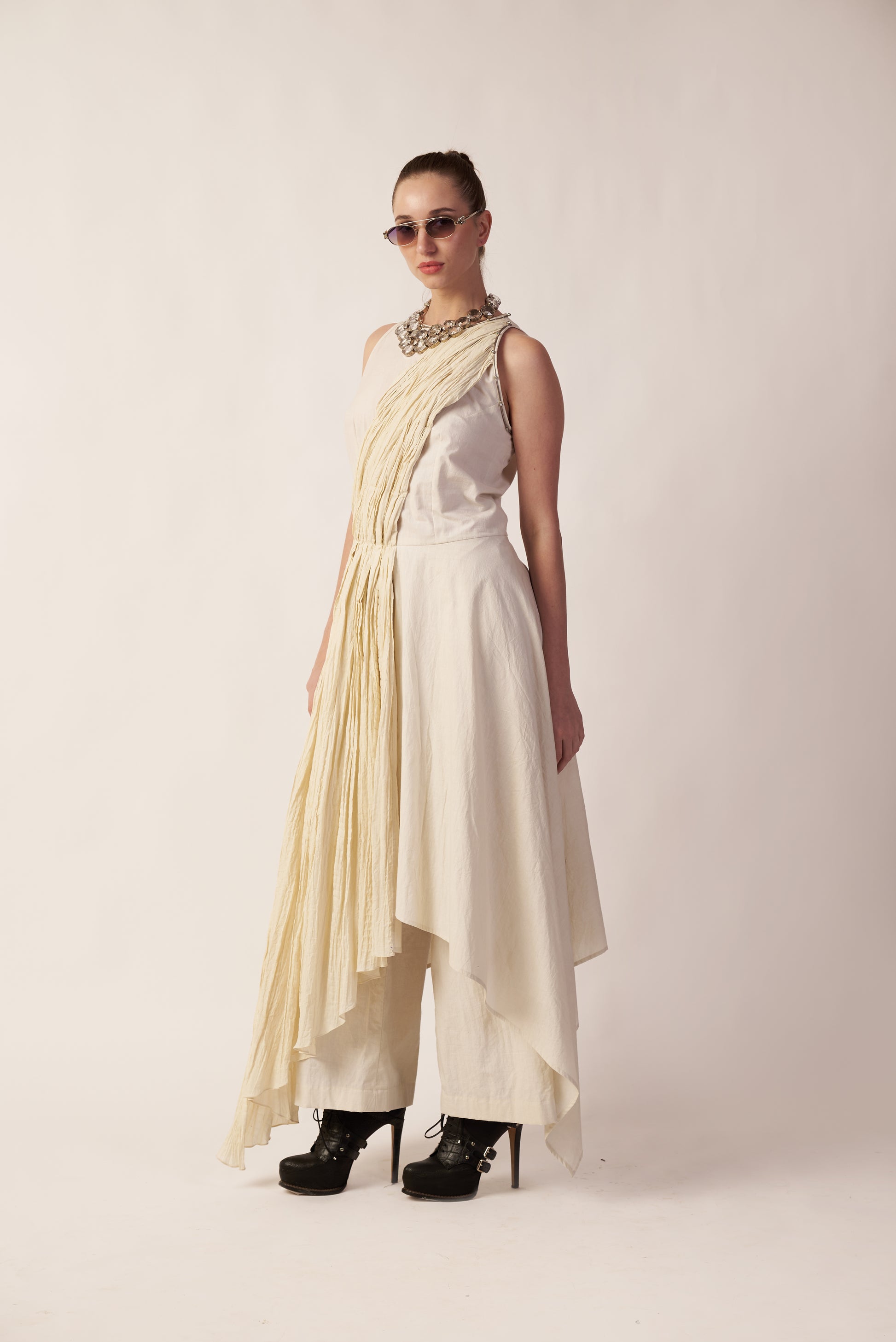 Woman wearing a long, light-colored scarf over a white dress  | Women Jumpsuit | Pret Clothes | nEo Clothes.
