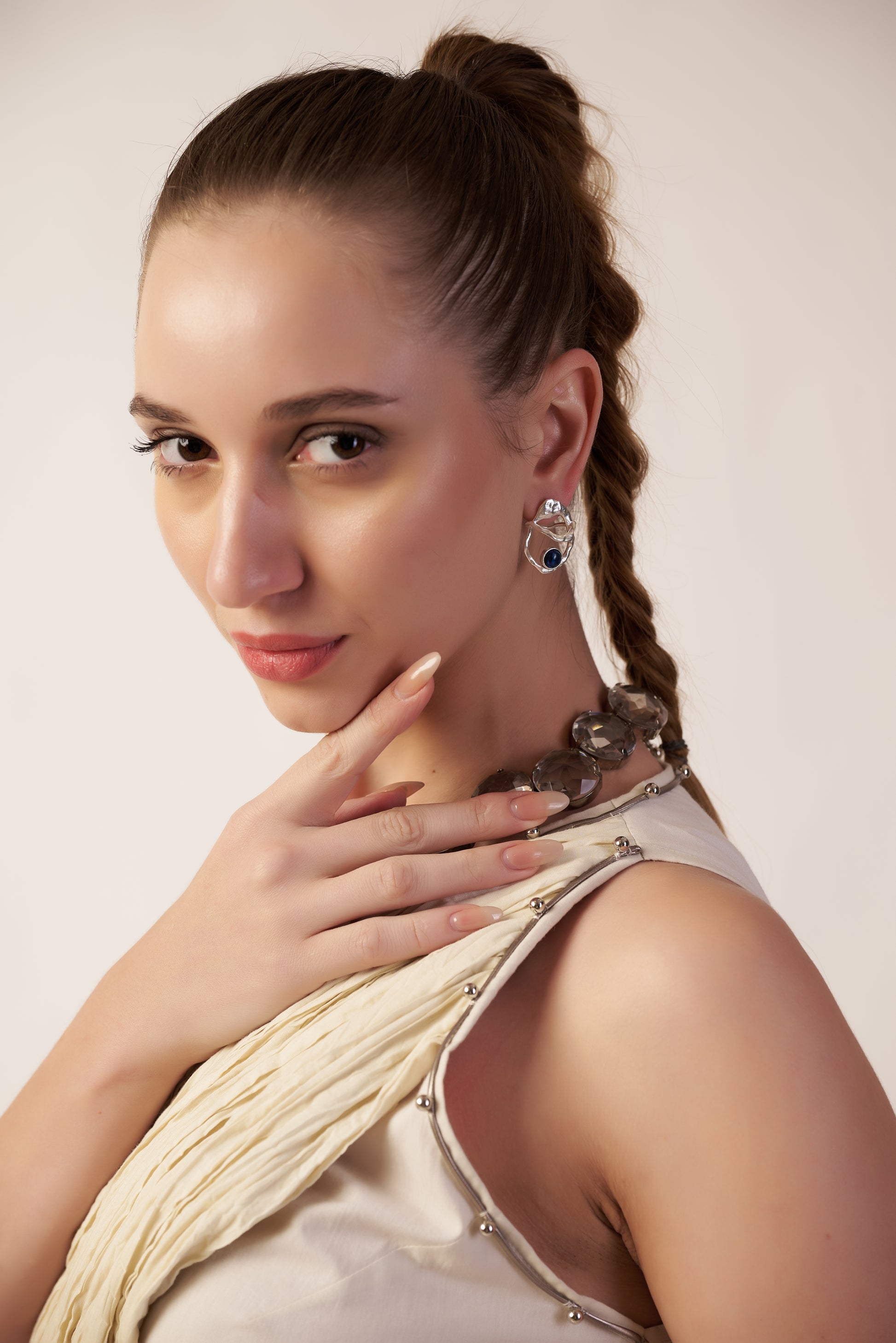 Woman with braided hair wearing silver earrings | Statement Earring | neo jewelry