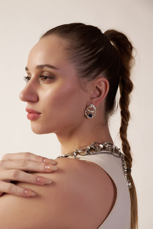 Woman with braided hair wearing a silver earrings | Statement Earring | neo jewelry