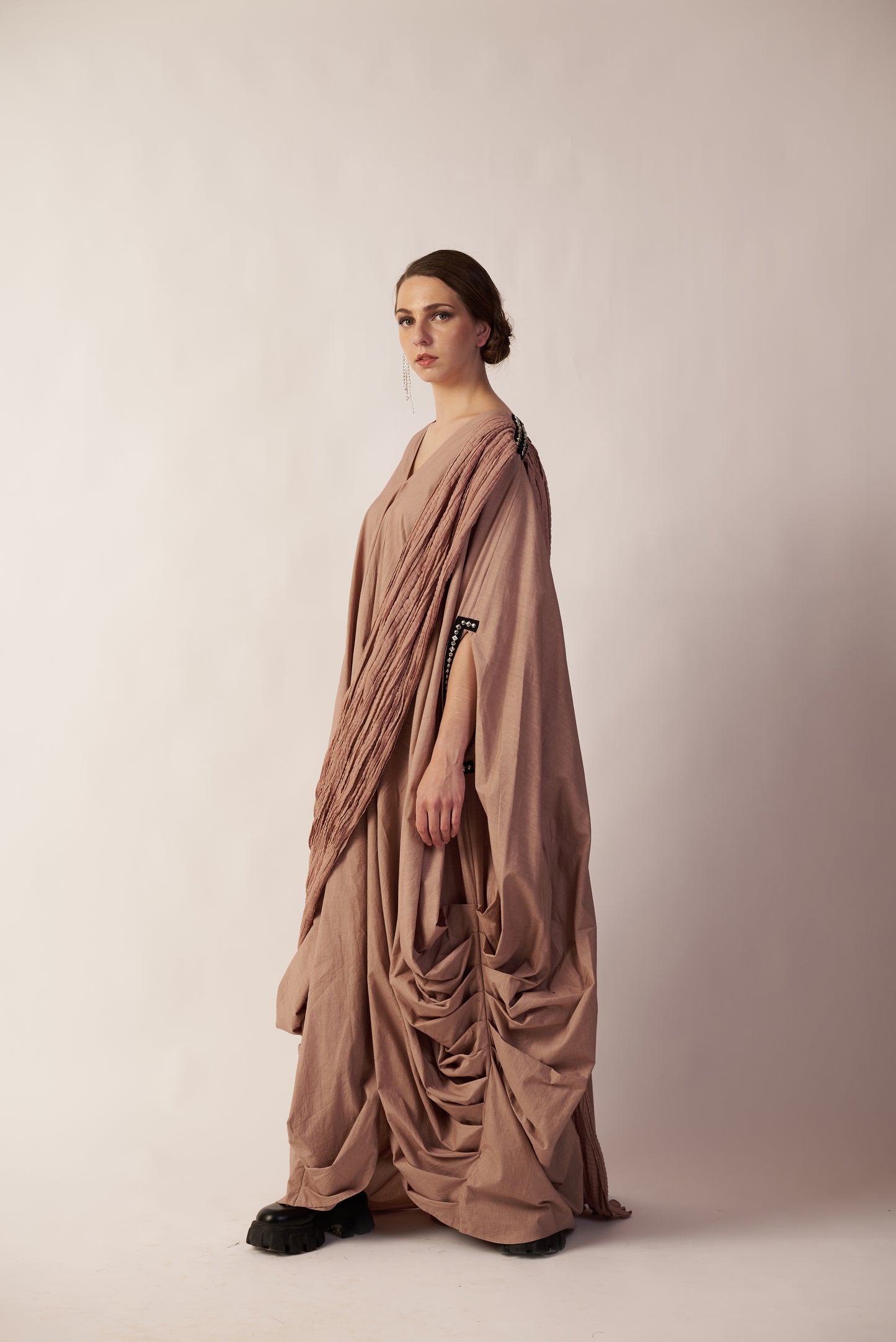 Woman wearing a flowing beige dress  with black shoes | Women Dresses | Pret Clothes | nEo Clothes.