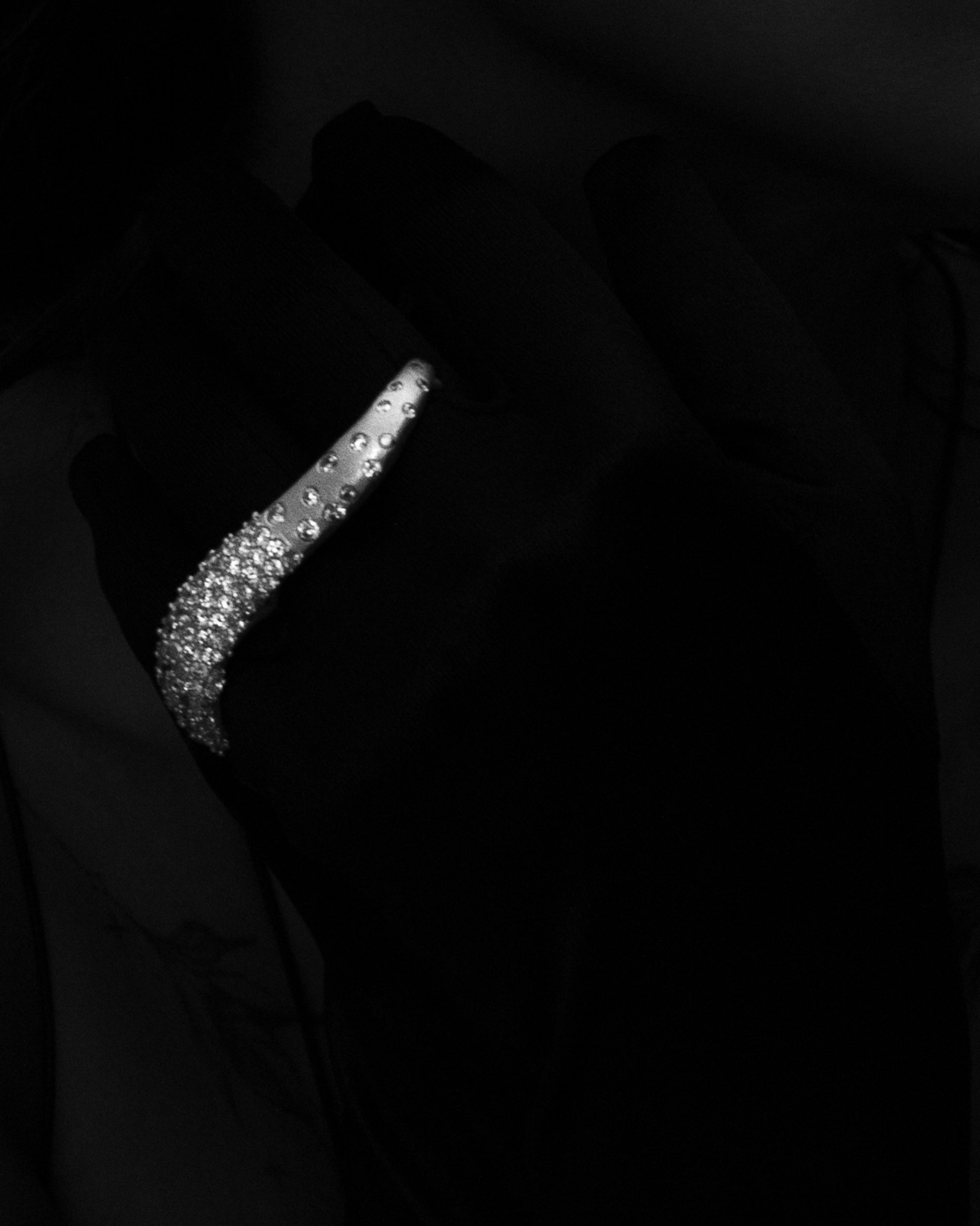 Near Earth Object | Close-up of a sparkling earring against a dark background