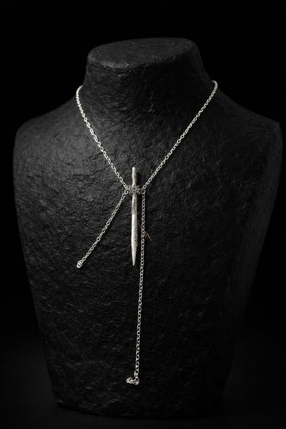 Near Earth Object | Silver necklace on a black stone bust against a black background