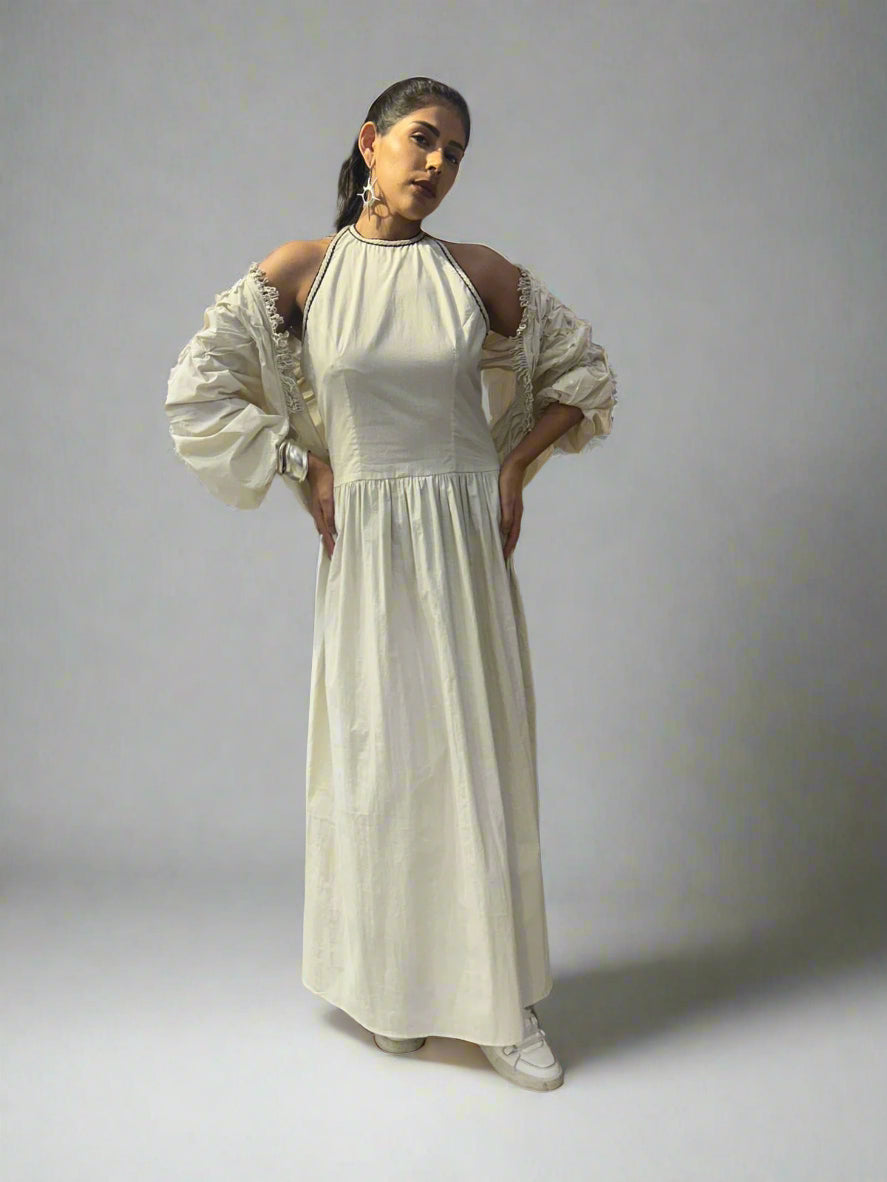 Woman wearing a long, light-colored dress with puffed sleeves | Women's Overlay & Camisole | Jacket | Pret Clothes | nEo Clothes.