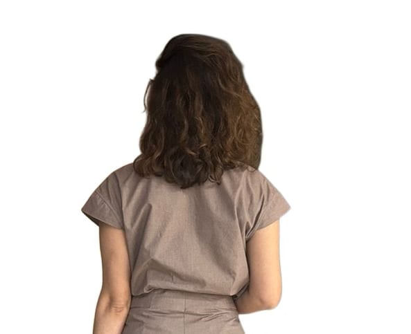 Back portrait of a woman wearing a taupe draped Top with short sleeves and structured waistline, showcasing the clean minimal back design, minimalist taupe brown dress showing back silhouette Top. | Women's Top  | Pret Clothes | Asymmetrical Top | nEo Clothes