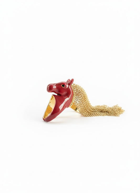 Red snake-shaped object with gold chain on a white background