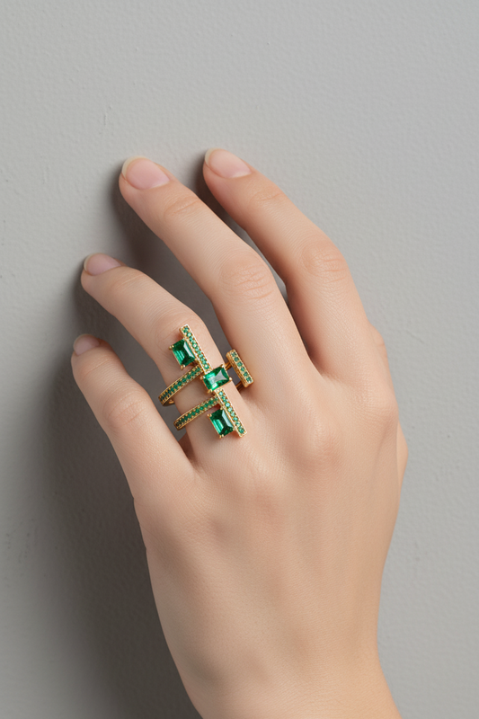 “Model wearing gold geometric ring with emerald-green stones and pavé detailing, showcasing its stacked multi-stone design – elegant statement jewellery by Near Earth Object.”