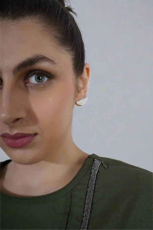 Model wearing minimal silver half-moon earrings – clean futuristic jewellery by Near Earth Object.